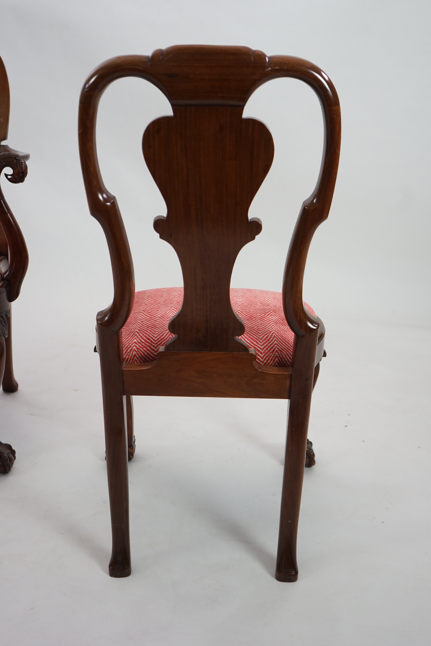 A set of twelve Queen Anne revival walnut dining chairs, including two carvers